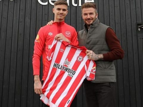 Done deal! Romeo Beckham (left) with his dad David after signing for Brentford.