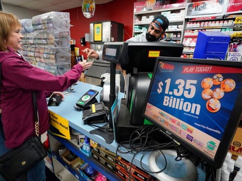 A Mega Millions sign displays the estimated jackpot of $1.35 billion as a customer purchases a Mega Millions ticket at the Cranberry Super Mini Mart in Cranberry, Pennsylavania, on January 12, 2023. Someone matched all six numbers Friday and won the jackpot, overcoming steep odds that led to three months of drawings without a winner. Sudden wealth will buy you relief from the drudgery of your old life, but what you don’t realise is that you’re about to live a life of stress.