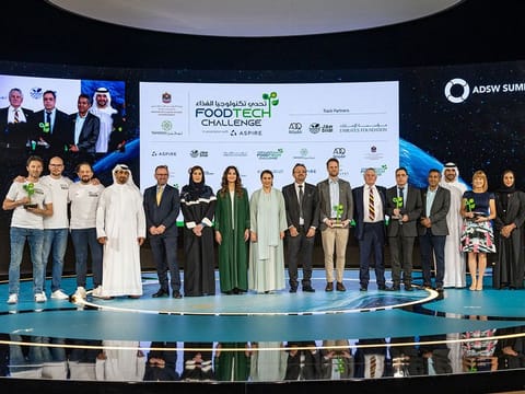 Winners (holding trophies) with UAE officials at the award ceremony in Abu Dhabi. Two winners are from the UK, and one each from the UAE and the Netherlands