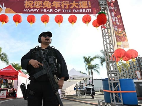 Monterey Park police officers stand at the scene of a mass shooting in Monterey Park, California.