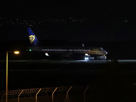 A Ryanair plane is seen on the runway, after landing at Athens' International Eleftherios Venizelos airport, following a bomb threat in midair, on the outskirts of Athens, Greece.