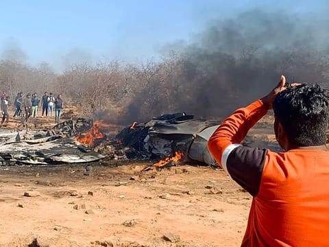 People gather near the wrecked remains after a Sukhoi-30 and Mirage 2000 aircraft crashed near Morena, Madhya Pradesh, on Saturday.