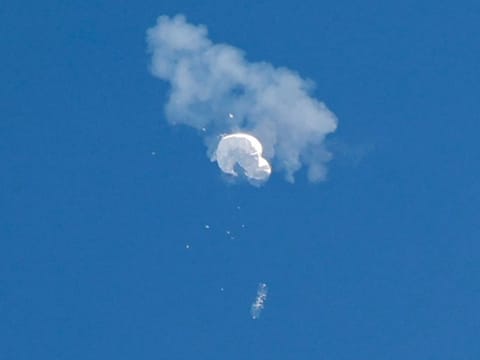 The suspected Chinese balloon drifts to the ocean after being shot down off the coast in Surfside Beach, South Carolina.