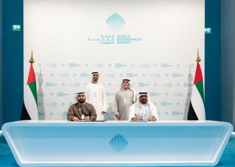 Omar Sultan Al Olama, Dr HamdanMusallam Al Mazrouei at the signing of Dh100m fund for digital education globally. Hamoud Abdullah Al Junaibi and Dr Waleed Al Ali signing the partnership.