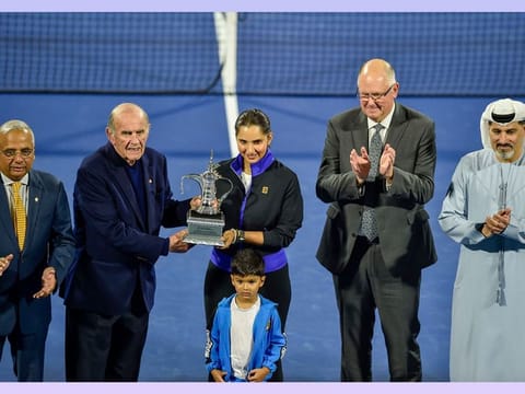 Colm McLoughlin handing over the replica of the women's singles trophy to Sania Mirza , Ramesh Chidambi, Steve Simon and Salah Tahlak watch during the felicitation ceremony at the centre court on Thursday.