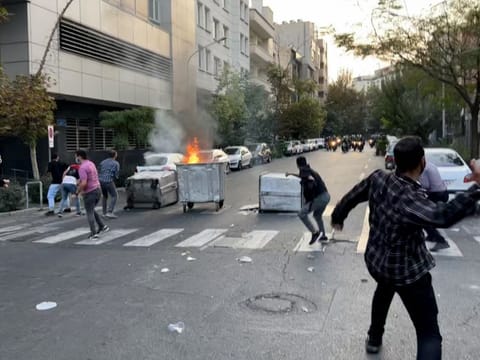 A file picture obtained by AFP outside Iran shows a bin burning in the middle of an intersection during a protest for Mahsa Amini, a woman who reportedly died after being arrested by the Islamic republic's "morality police", in Tehran.