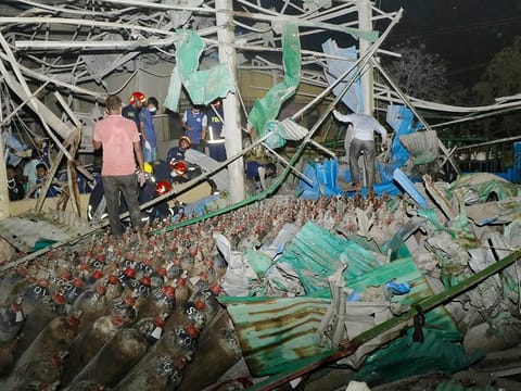 Firefighters and rescue workers gather at the site of an explosion at an oxygen plant on the outskirts of Chittagong on March 4, 2023.