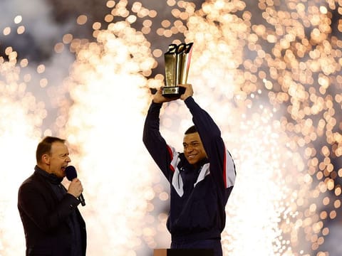 Paris St Germain's Kylian Mbappe celebrates with a trophy during the ceremony after becoming Paris St Germain's all time top goalscorer with 201 goals