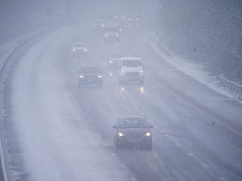 Cars driving through snow on the northbound carriageway of the M5 motorway near Taunton, which has been reduced to two lanes due to snow, as parts of the UK wake up to snow and a yellow weather warning, Wednesday March 8, 2023.