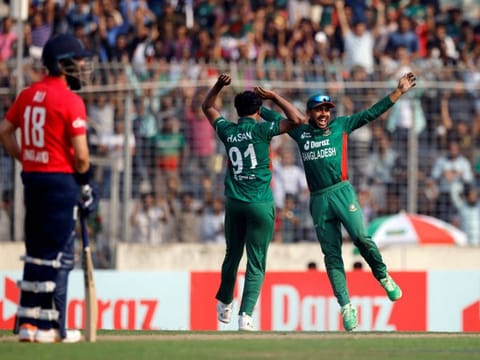 Bangladesh's Hasan Mahmud celebrates with Mehidy Hasan Miraz after taking the wicket of England's Jos Buttler at the Sher-E-Bangla National Cricket Stadium, Dhaka, Bangladesh.