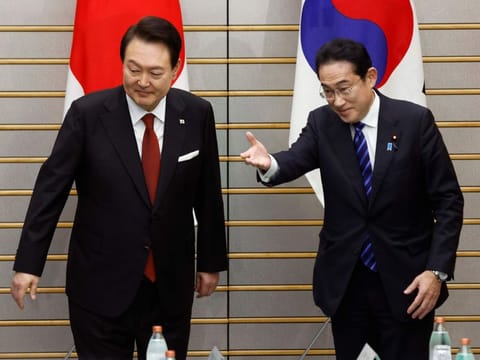 South Korean President Yoon Suk Yeol, left, is escorted by Japanese Prime Minister Fumio Kishida, right, ahead of their bilateral meeting at the Prime Minister's Office, in Tokyo, Japan, Thursday, March 16, 2023.