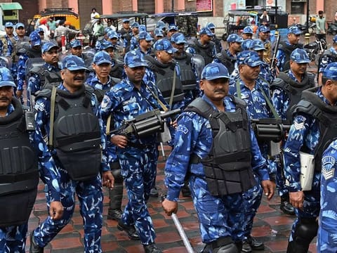 India's Rapid Action Force (RAF) personnel patrol along a street during a hunt for Sikh separatist, in Amritsar on March 20, 2023.