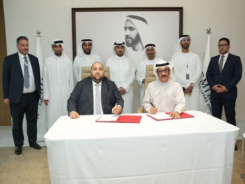(Sitting) Adam Ladjadj, Chairman of the Emirates Family Office Association and Jamal Aljarwan, Secretary General - UAE International Investors Council (UAEIIC) signing the MoU (standing from left) Imran Khan and Fahad Ahbabi, Co-founders of the Emirates Family Office Association, ADGM CEO, Dhaher Bin Dhaher Al Mheiri, Mohamed Al Sabah, Nasser Al Nowais, Chairman of Rotana Hotel Management Corporation PJSC and Aswaq Management, and Ahmed Nasser Al Nowais