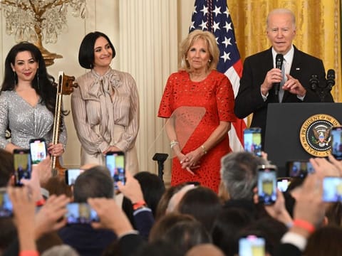 Musician Sahba Motallebi, Iranian-US singer-songwriter Rana Mansour, and US First Lady Jill Biden look on as US President Joe Biden speaks during a Nowruz reception in the East Room of the White House in Washington, DC, on March 20, 2023.