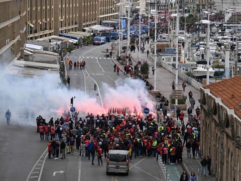 Protesters gather prior to the start of a demonstration on a national action day, a week after the government pushed a pensions reform through parliament without a vote, using the article 49.3 of the constitution, in Marseille, southern France, on March 23, 2023.
