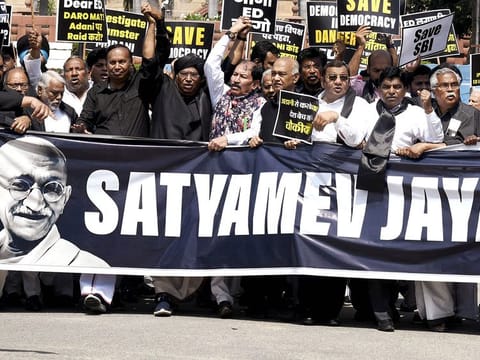 Leader of Opposition Mallikarjun Kharge and Opposition MPs wearing black attire take out a protest march from Parliament complex towards Vijay Chowk over the Adani Group issue, in New Delhi on Monday