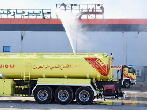 Civil defence teams at the hypermarket where the fire broke out in Umm Al Quwain on MOnday.
