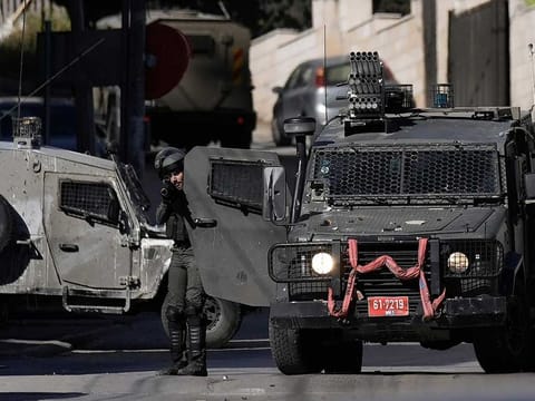 Israel policeman shoots tear gas during clashes with Palestinians during a raid in the West Bank city of Nablus, Monday, April 3, 2023.