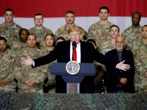 US President Donald Trump delivers remarks to troops, with Afghanistan President Ashraf Ghani standing behind him, during an unannounced visit to Bagram Air Base, Afghanistan, November 28, 2019.