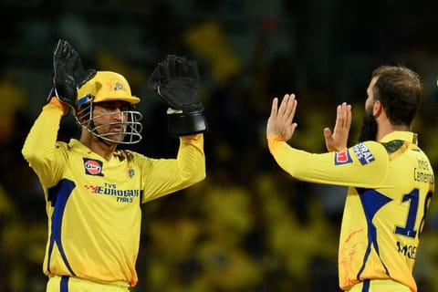 Chennai Super Kings' Moeen Ali (right) celebrates with his captain Mahendra Singh Dhoni after taking the wicket of Lucknow Super Giants' Krunal Pandya (not pictured) during the Indian Premier League match at the MA Chidambaram Stadium in Chennai.