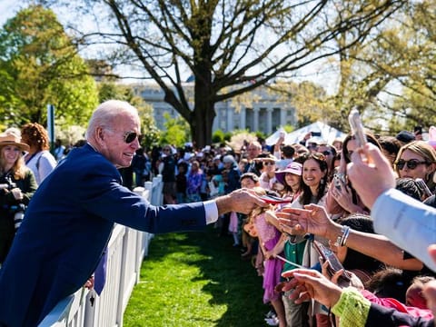 President Joe Biden greets guests during the White House Easter Egg Roll on the South Lawn. This year's theme was centered around educational opportunities, and activities across the lawn included a visit to a school house, a field trip to the farm and a reading nook.