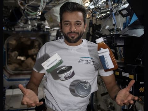 Archive image of Dr Al Neyadi juggling food canisters and packages in the microgravity environment - which he is missing back on Earth - onboard the International Space Station in April 2023