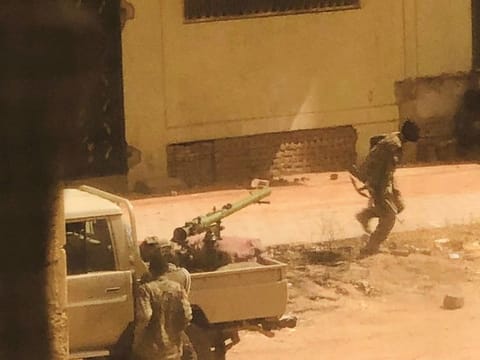 A military vehicle and soldiers said to be from the Sudanese armed forces are seen on a street in Khartoum on April 15, 2023 in this picture screen grab obtained from a social media video.
