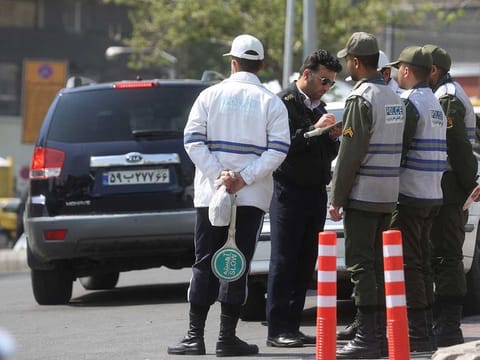 Iran's police forces stand on a street amid the implementation of the new hijab surveillance in Tehran, Iran, April 15, 2023.