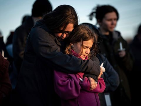 Sarah Tuck, of Lebanon, Tenn., prays with her daughter Emmalin Sweeney, 10, during a community vigil held for the people killed during the Covenant School shooting on Tuesday, March 28, 2023, in Mt. Juliet, Tenn.