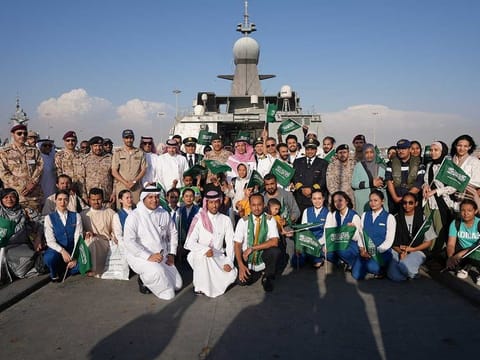 Saudi citizens and staff of Saudi Airline pose for a group photo as they arrive at Jeddah Sea Port after being evacuated on a Saudi Navy Ship from Sudan to escape the conflict, Jeddah, Saudi Arabia, April 23, 2023.