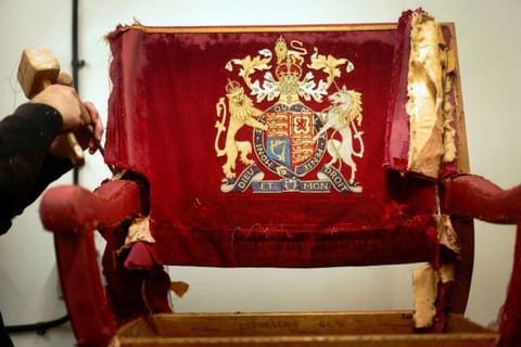 An upholsterer works on restoring a throne chair at Marlborough House, ahead of the Coronation of King Charles and Camilla, Queen Consort on May 6., in London, Britain February 17, 2023.
