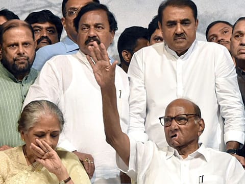 NCP President Sharad Pawar indicates to supporters to be quiet as wife Pratibha Pawar gets emotional while announcing his retirement from the party post at YB Chawan Auditorium in Mumbai on Tuesday. Party leader Praful Patel also seen. Pawar’s daughter Sule, nephew Ajit Pawar and grand nephew Rohit Rajendra Pawar are possible replacements.