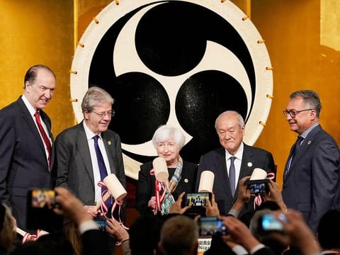 From left: World Bank Group President David Malpass, Commissioner for the Economy of the European Commission Paolo Gentiloni, US Treasury Secretary Janet Yellen, Japanese Finance Minister Shunichi Suzuki, and Joachim Nagel, president of the Deutsche Bundesbank, break sake barrels during the welcoming reception of the G7 meeting of Finance Ministers and Central Bank Governors at Toki Messe in Niigata on May 11, 2023.