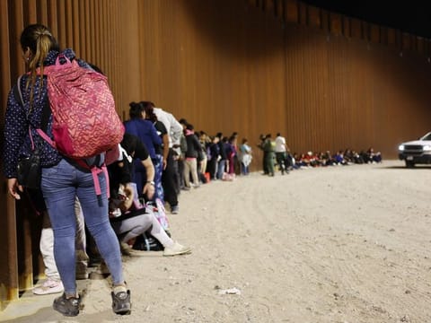 Immigrants seeking asylum, who were apprehended at the time Title 42 expired, are processed by US Border Patrol agents, after crossing into Arizona from Mexico, on May 11, 2023 in Yuma, Arizona.