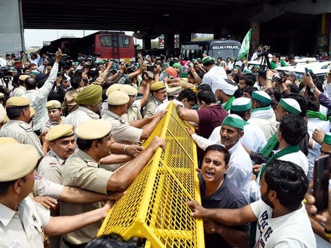 Farmers being stopped by police personnel at the Ghazipur border who arrive to join the protesting wrestlers' marching towards the new Parliament House against Wrestling Federation of India (WFI) president Brij Bhushan, in New Delhi on Sunday, May 28, 2023.