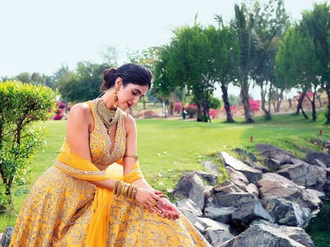 Outfit Raw silk mirror work lehenga and blouse set (with dupatta) Dh4,303, Frontier Raas - Dubai, @frontierraasdubai Jewellery Kundan choker, earrings, bangles, arm band and rings in 22K gold with antique finish all by Kanz Jewels