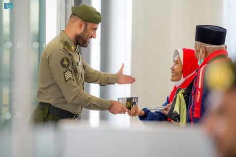 A Saudi passport official welcomes Indonesian pilgrims.
