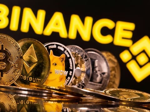 FILE PHOTO: Representations of cryptocurrencies Bitcoin, Ethereum, DogeCoin, Ripple, and Litecoin are seen in front of a displayed Binance logo in this illustration taken, June 28, 2021. REUTERS/Dado Ruvic/Illustration/File Photo