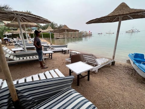 A worker stands on one of the beaches that have been closed after a Russian citizen was killed in a shark attack near a beach at the Egyptian Red Sea resort of Hurghada, on June 9, 2023.