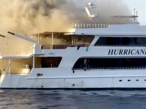 Plumes of smoke erupt from a yacht on fire in Marsa Alam, Egypt, June 11, 2023 in this screengrab taken from a handout video.