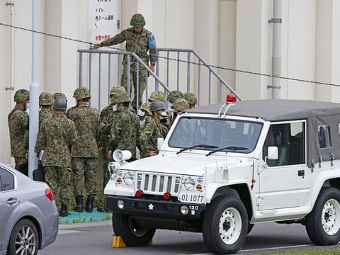 Members of the Japanese Self-Defence Force (SDF) are seen around the shooting range, in which a teenage member of SDF was arrested on suspicion of attempted murder after a shooting incident, in Gifu, Gifu Prefecture, on June 14, 2023.
