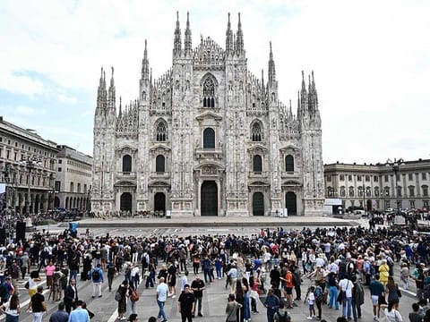 People gather outside the Duomo cathedral in Milan on June 14, 2023 ahead of the state funeral for Italy's former prime minister and media mogul Silvio Berlusconi.