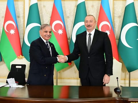 Pakistan Prime Minister Shehbaz Sharif and President of Azerbaijan Ilham Aliyev shake hands during a meeting in Baku on June 15, 2023.