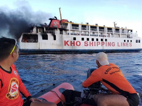 Coast guard personnel assist in putting out the fire on Philippine ferry M/V Esperanza Star at the waters off Panglao, Bohol province.