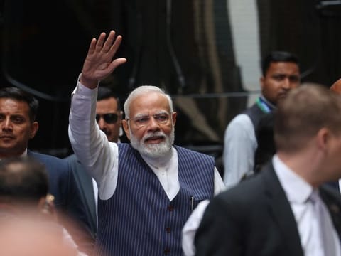 Indian Prime Minister Narendra Modi waves to supporters as he arrives in New York City on June 20, 2023