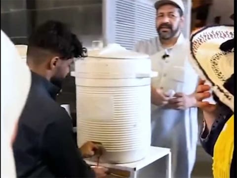 A screen garb of Abu Adel serving drinks to pilgrims in Mecca.