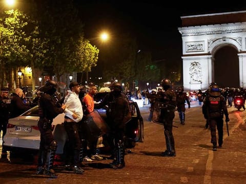 Police detain young people during the fifth night of protests on July 2, 2023, in the Champs Elysees area, in Paris, France.