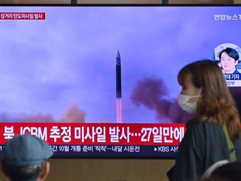 A news broadcast with file footage of a North Korean missile test, at a railway station in Seoul on July 12, 2023.