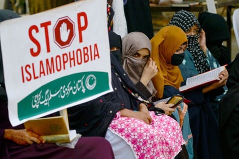 Activists and supporters of Pakistan Markazi Muslim League (PMML) party read the Quran during an anti-Sweden demonstration in Karachi on July 9, 2023.