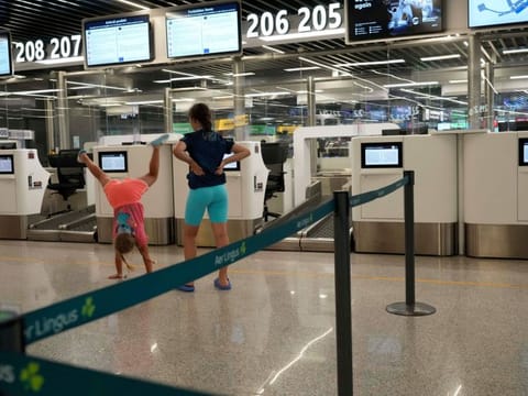 Children play in front of empty check in counters during a nationwide strike of airports ground staff, and check-in services at Rome's Fiumicino International airport in Fumicino, Italy, Saturday, July 15, 2023.